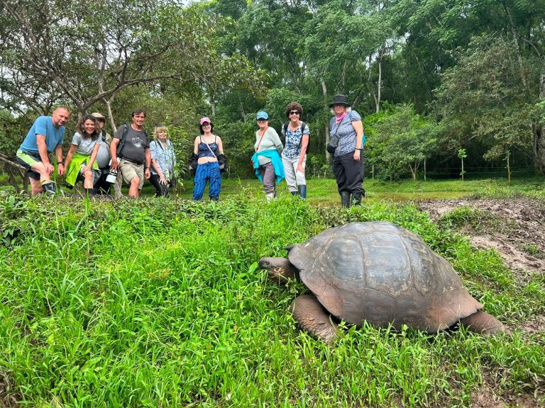 Travelers with Giant Tortoise in the Galapagos