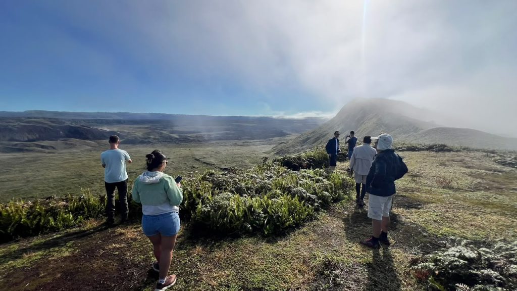 Travelers at the Sierra Negra Volcano Crater viewpoint.